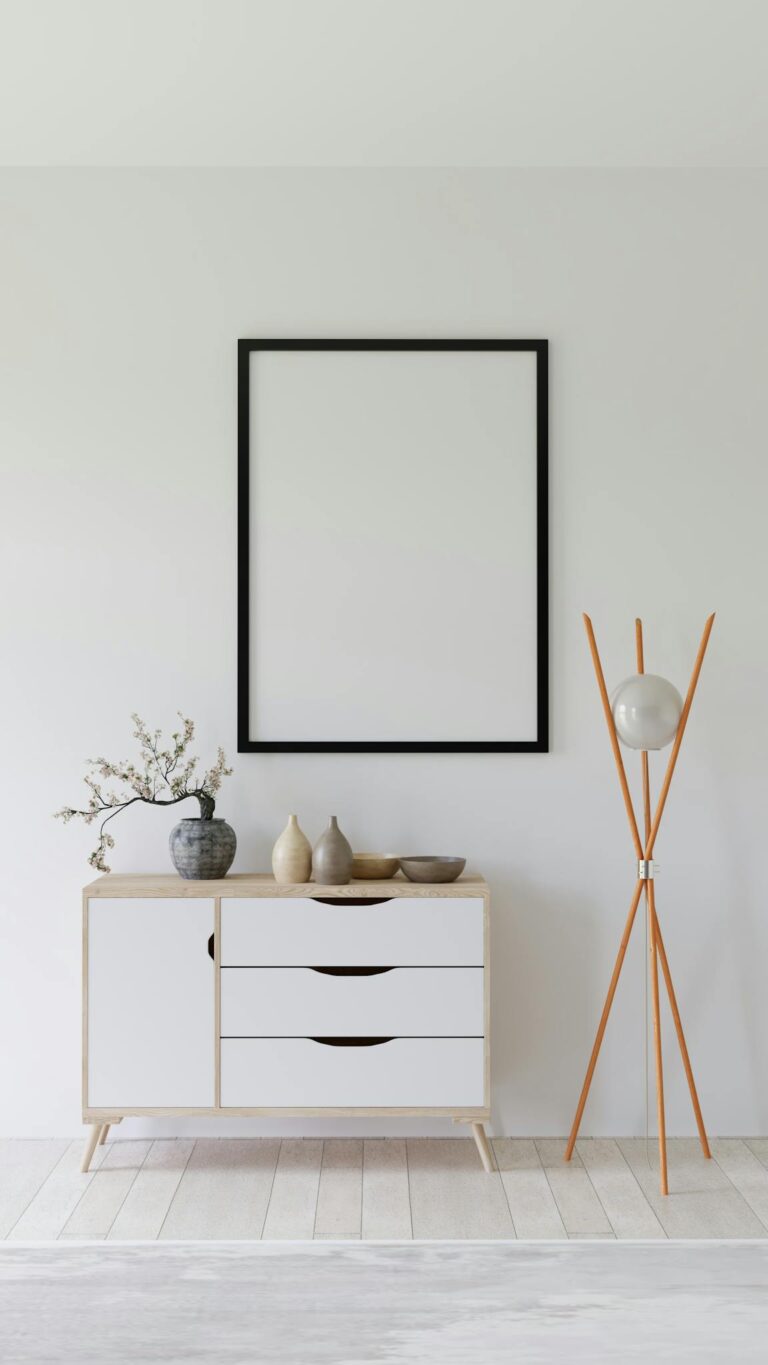 Elegant minimalist interior with empty frame, credenza, and modern decor.