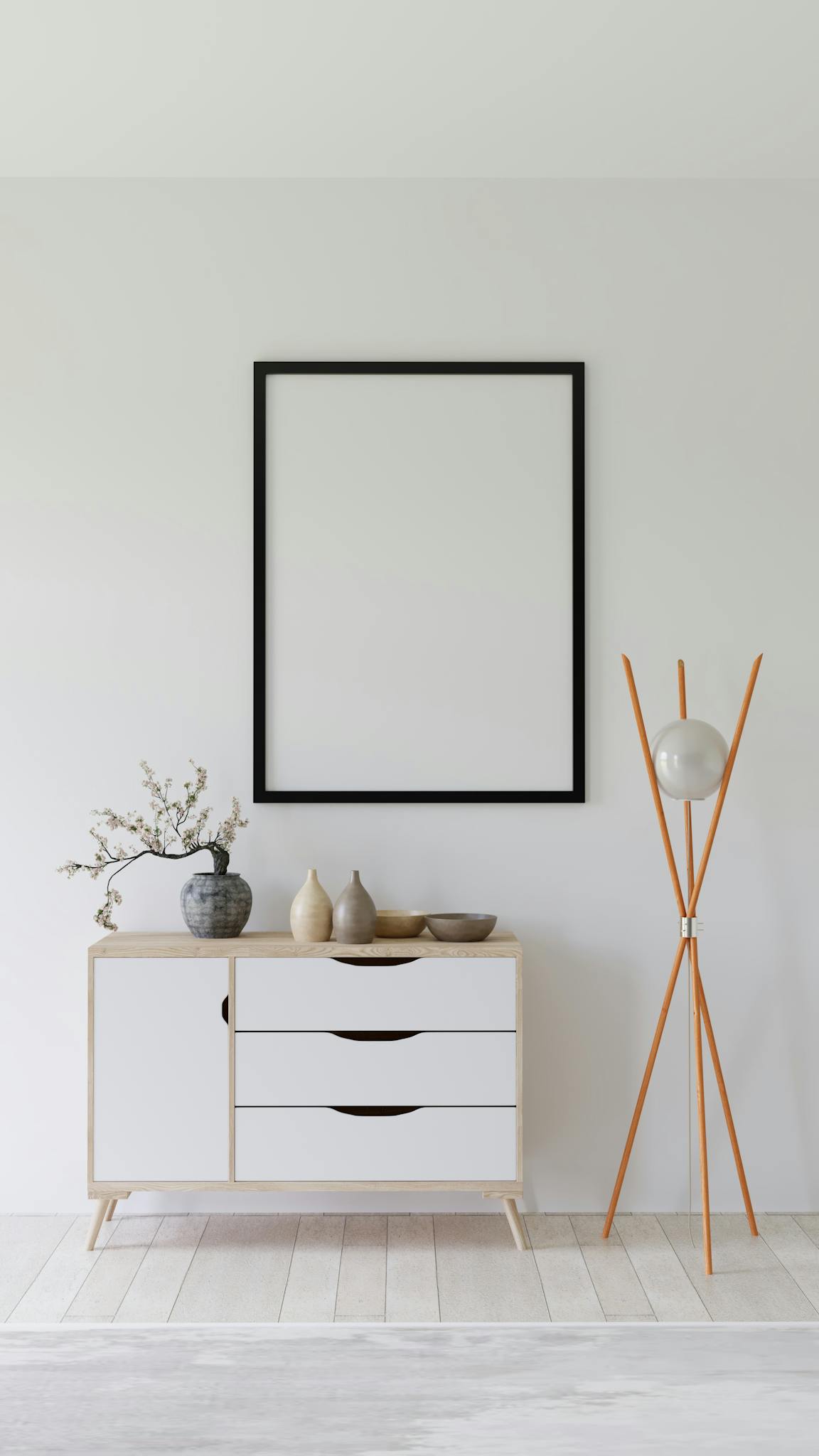 Elegant minimalist interior with empty frame, credenza, and modern decor.